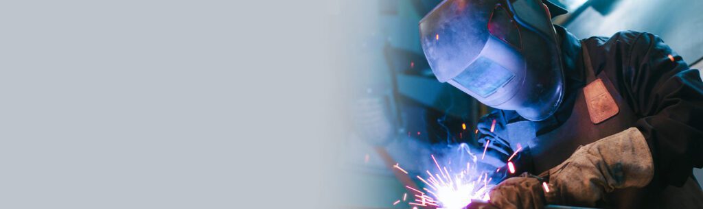 A welder working in a factory shop.